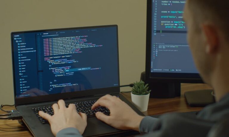 Software engineer writing code on a laptop